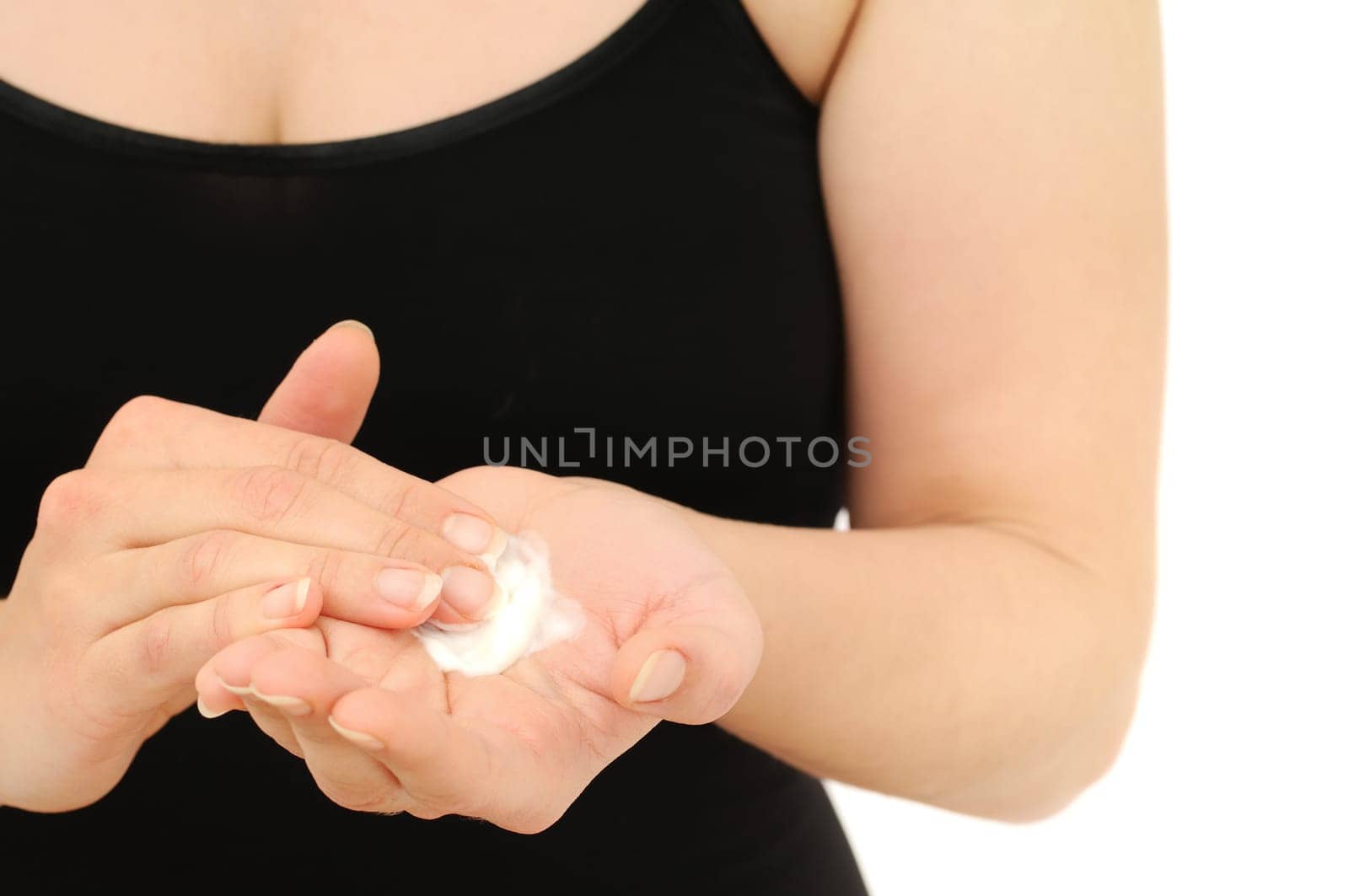 Woman in underwear applies cream on dry hands