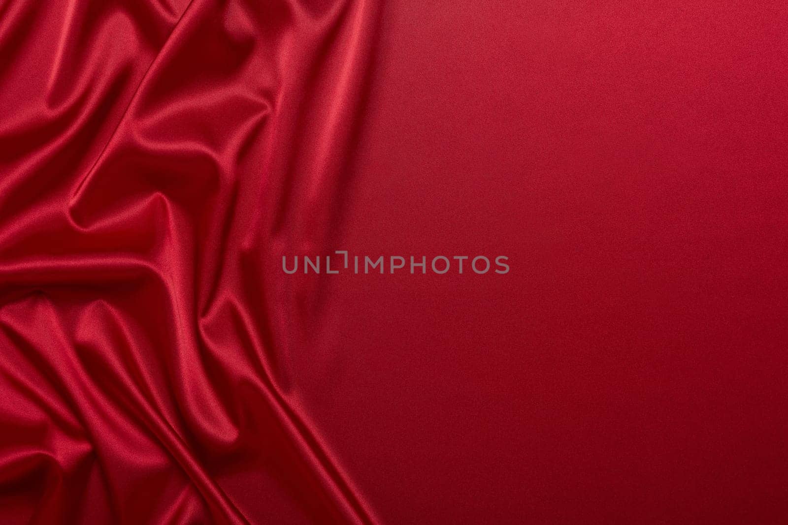 Abstract background from red silk or satin. Luxury fabric texture with draped. Top view with copy space. Element design. Valentine's day.