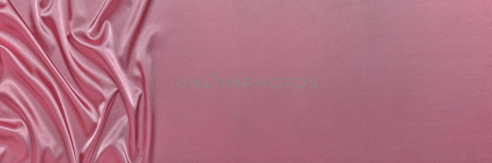 Abstract background from pink silk or satin. Luxury fabric texture with draped. Top view with copy space. Element design. Valentine's day.