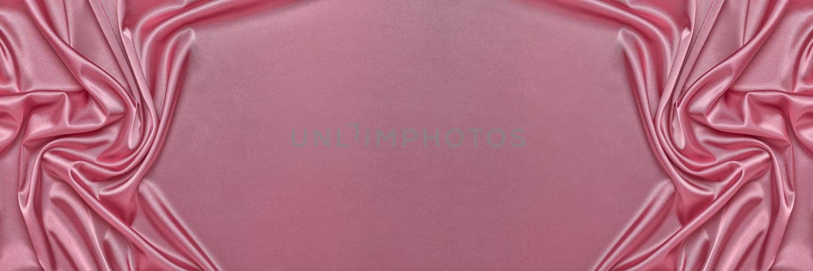 Abstract background from pink silk or satin. Luxury fabric texture with draped. Top view with copy space. Element design. Valentine's day.