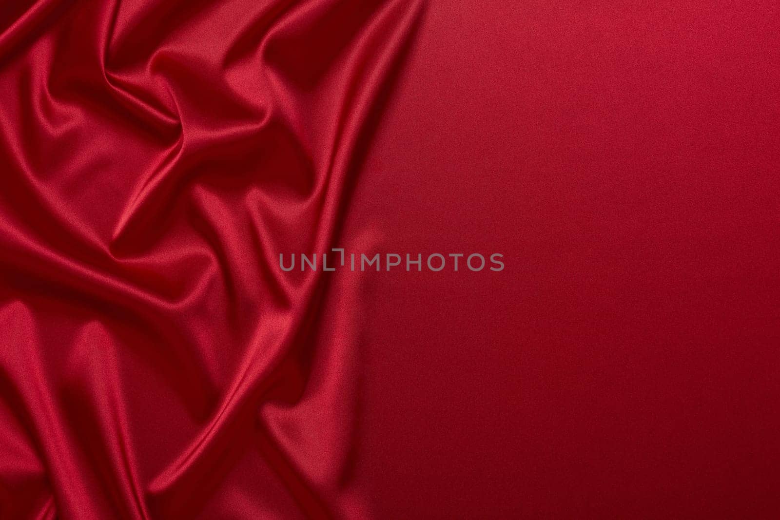 Abstract background from red silk or satin. Luxury fabric texture with draped. Top view with copy space. Element design. Valentine's day.