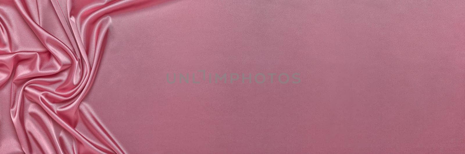 Abstract background from pink silk or satin. Luxury fabric texture with draped. Top view with copy space. Element design. Valentine's day.