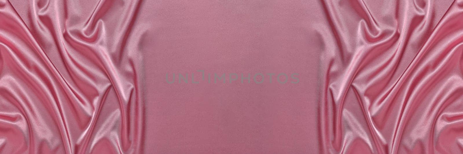 Abstract background from pink silk or satin. Luxury fabric texture with draped. Top view with copy space. Element design. Valentine's day.