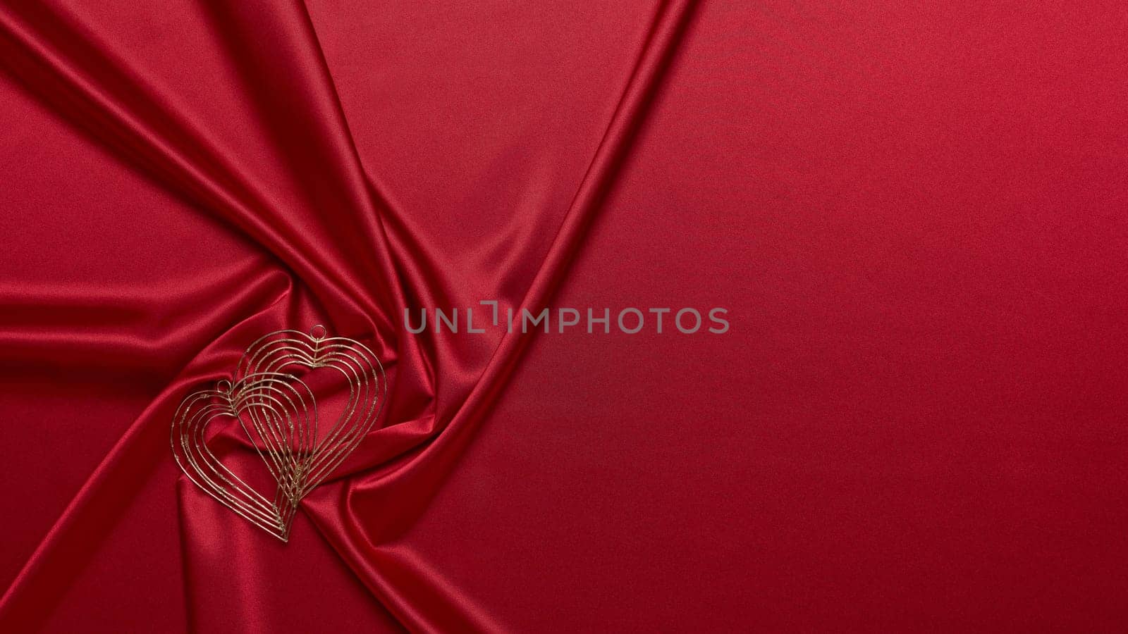 Abstract background from red silk (satin) and heart. Fabric texture with draped. Top view with copy space. Element design. Valentine's day. Wedding day. Greeting card