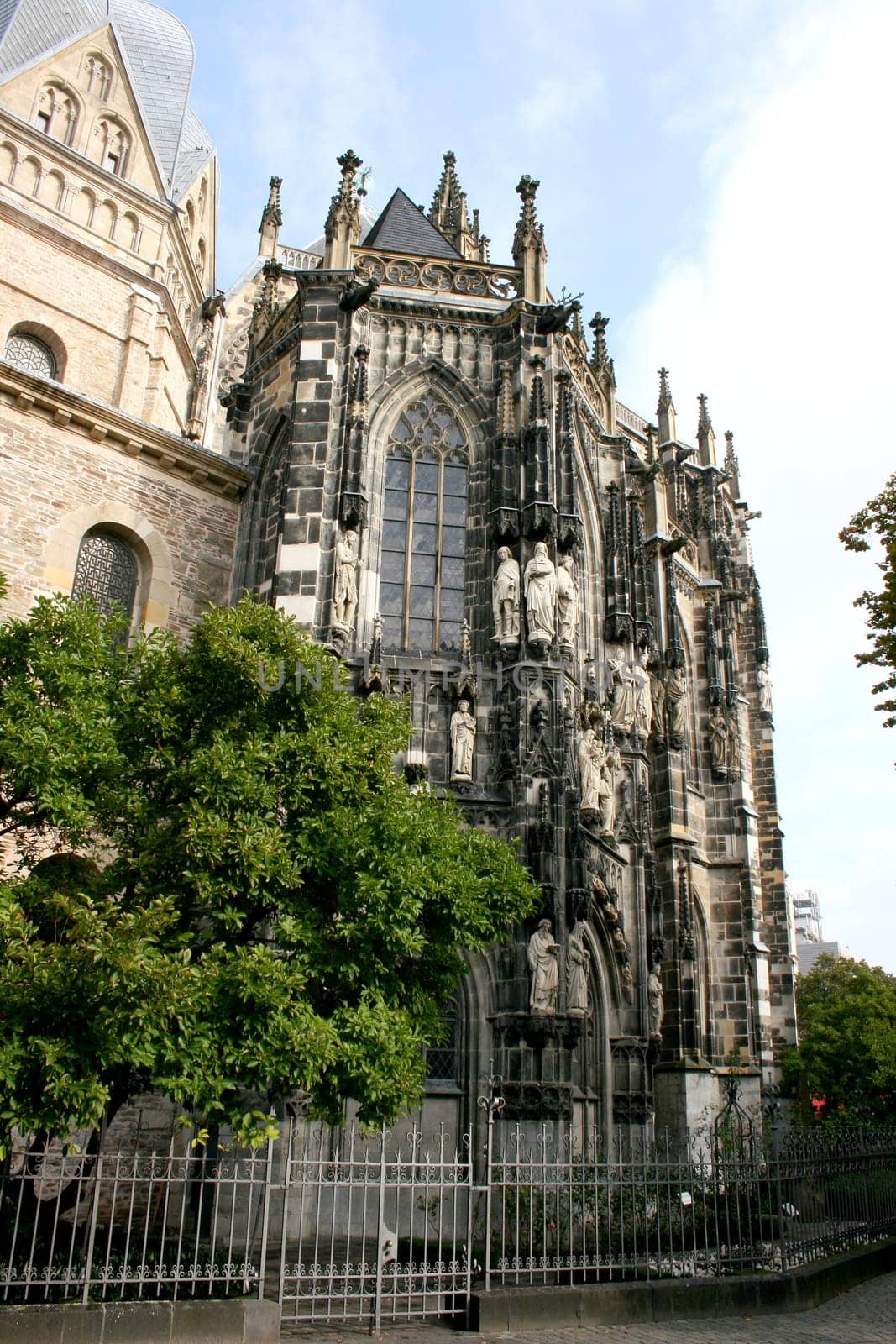 Side view of a church, with statues on the façade
