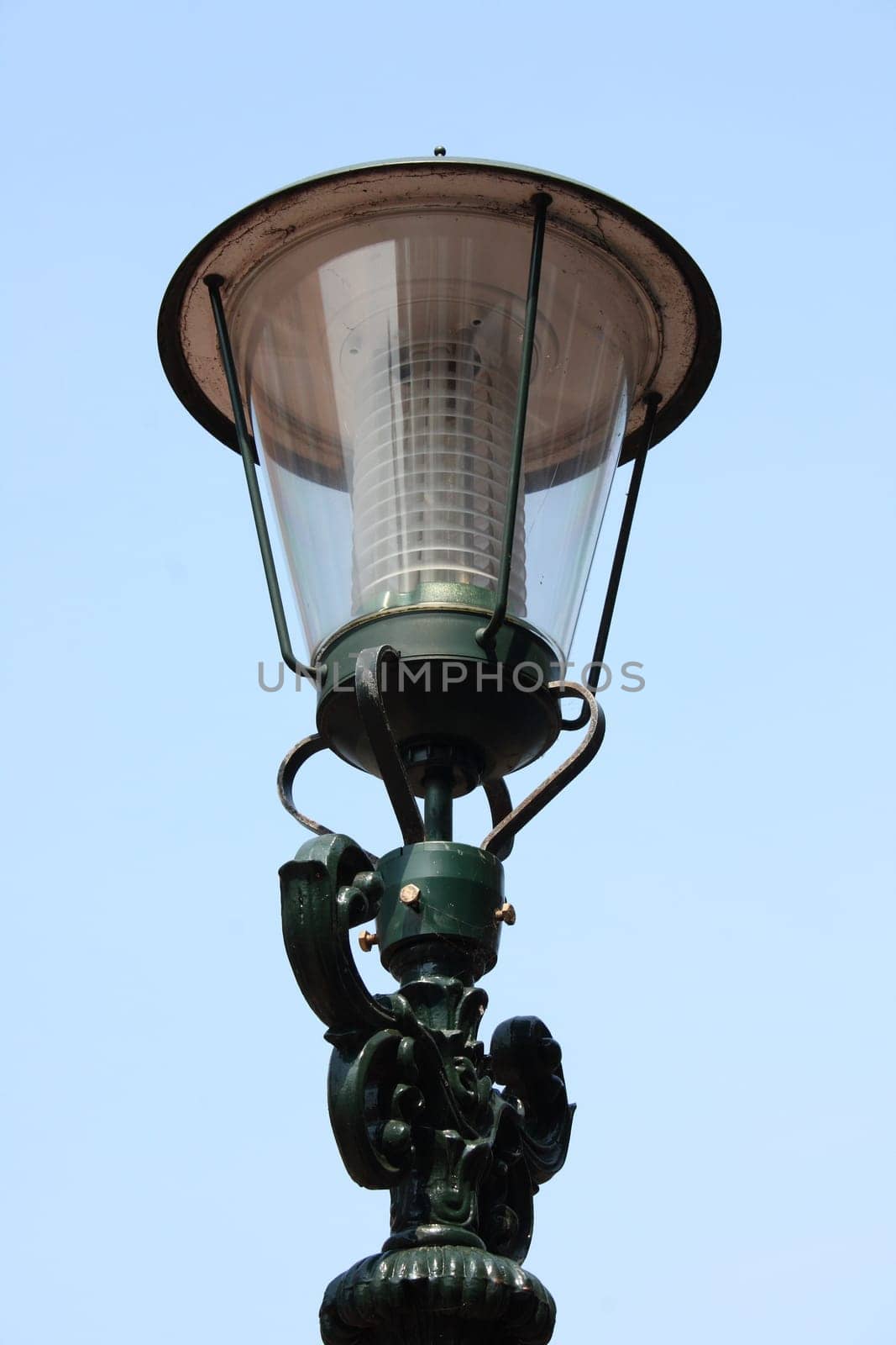 A decorated street lamp, blue sky in the background