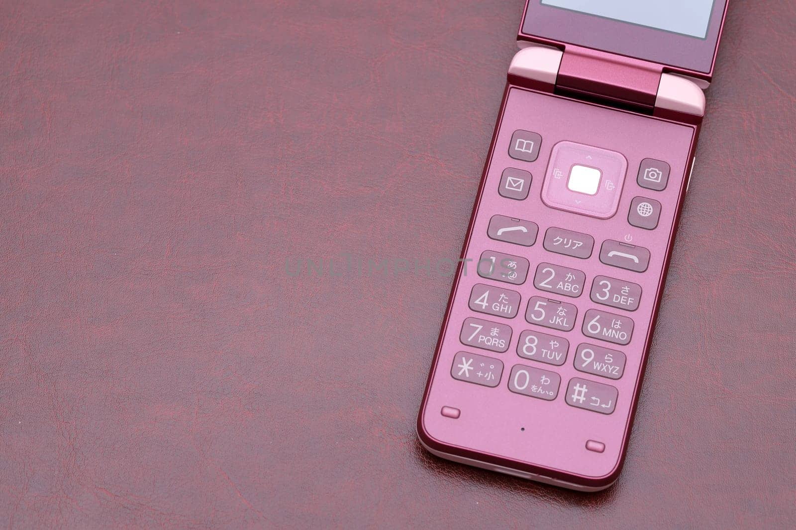 Japanese Mobile phone on table, Garake. Japanese word of this photography "Japanese cursive characters"""