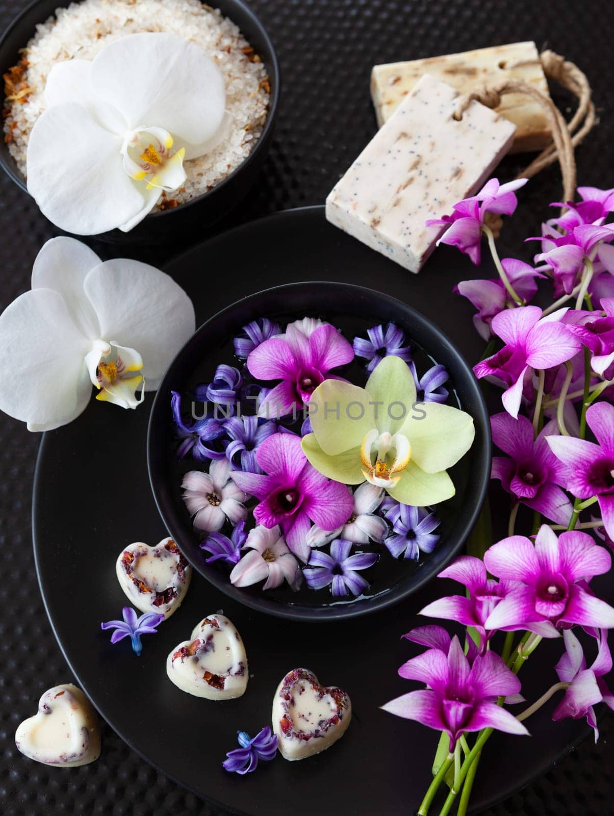 Fresh orchids and hyacinths with natural bath products