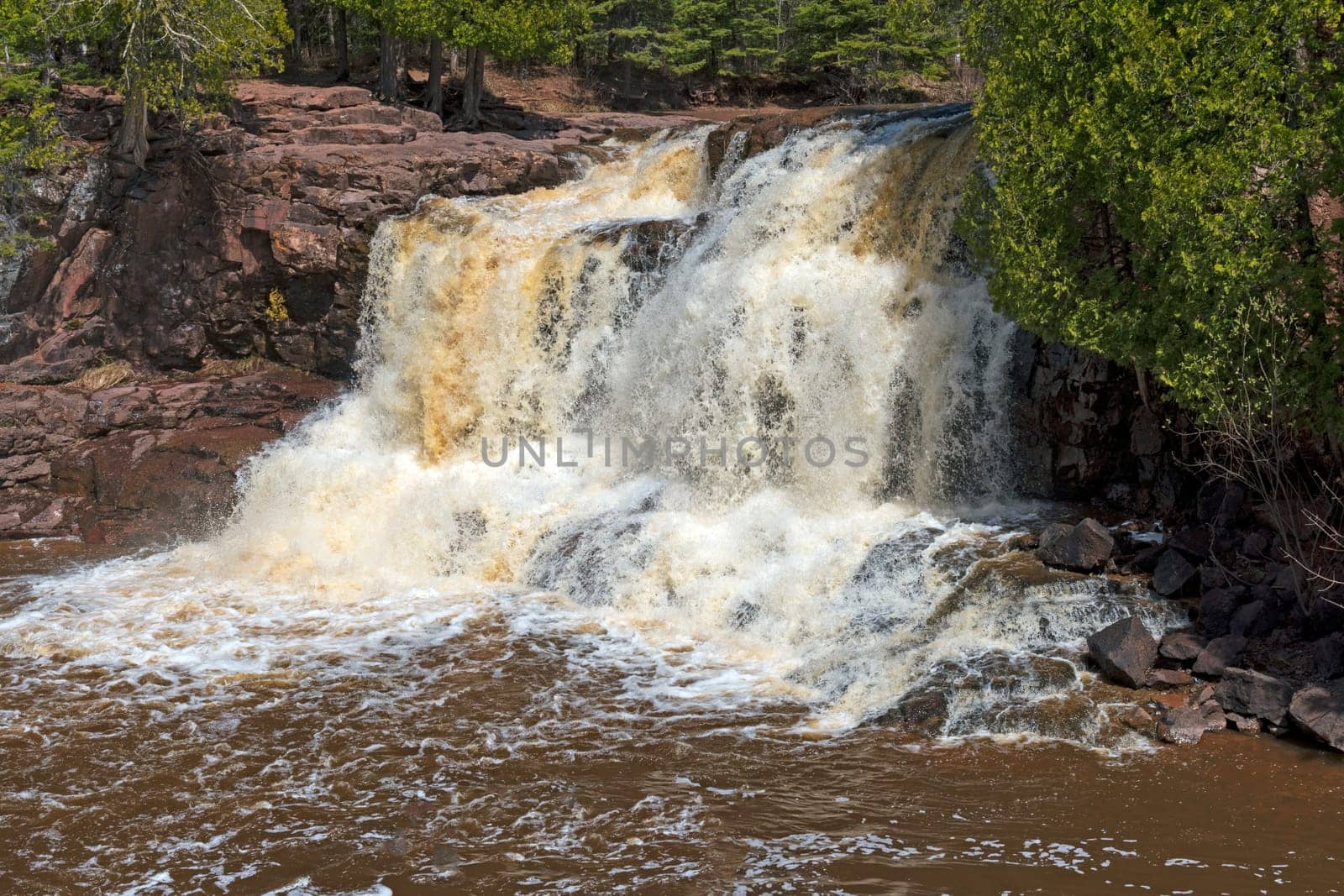 Spring Waters on Upper Goosebery Falls amidst Red Rocks in Gooseberry Falls State Park in Minnesota