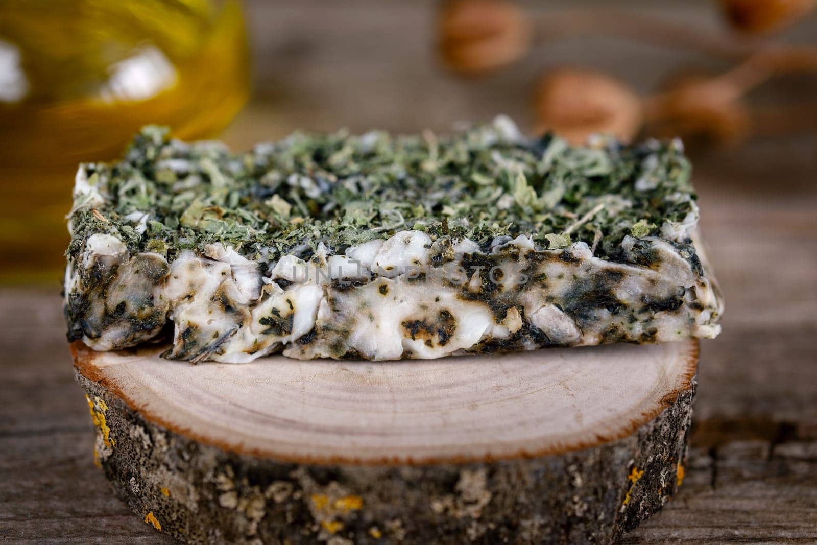 Handmade scrub soapHandmade scrub soap on a wooden stand with dry mint for relaxation and water treatments