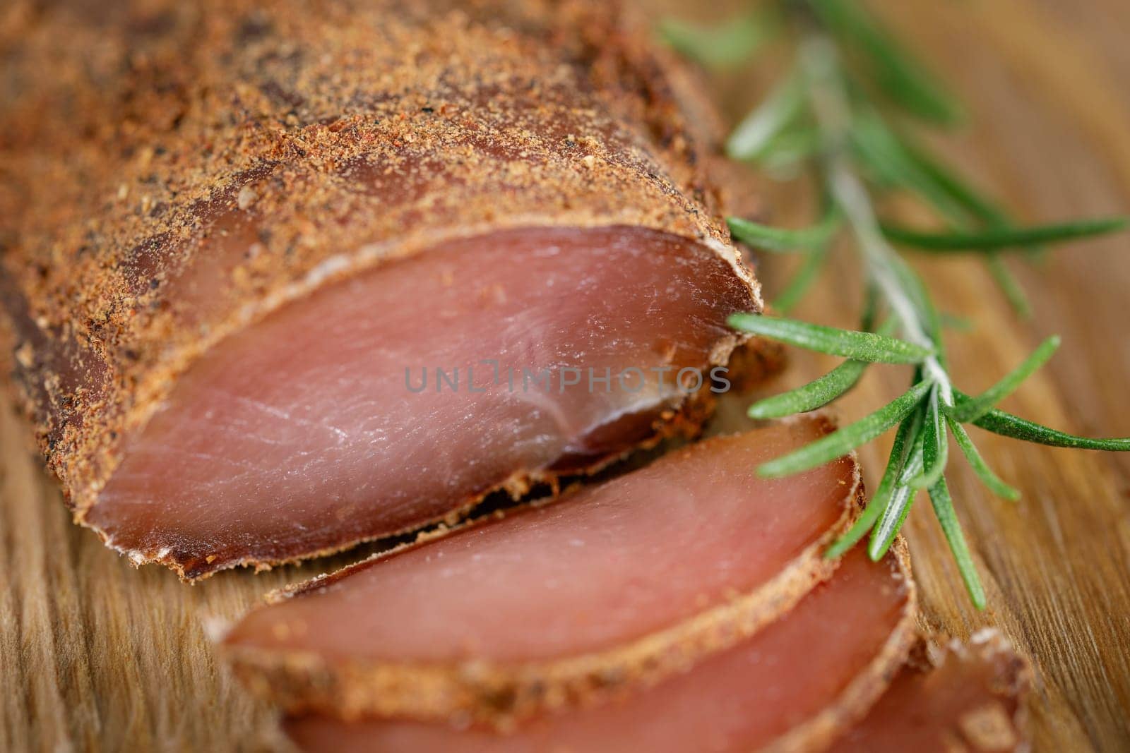 Chicken breast jerky, basturma with spices on a wooden board, slice with slices