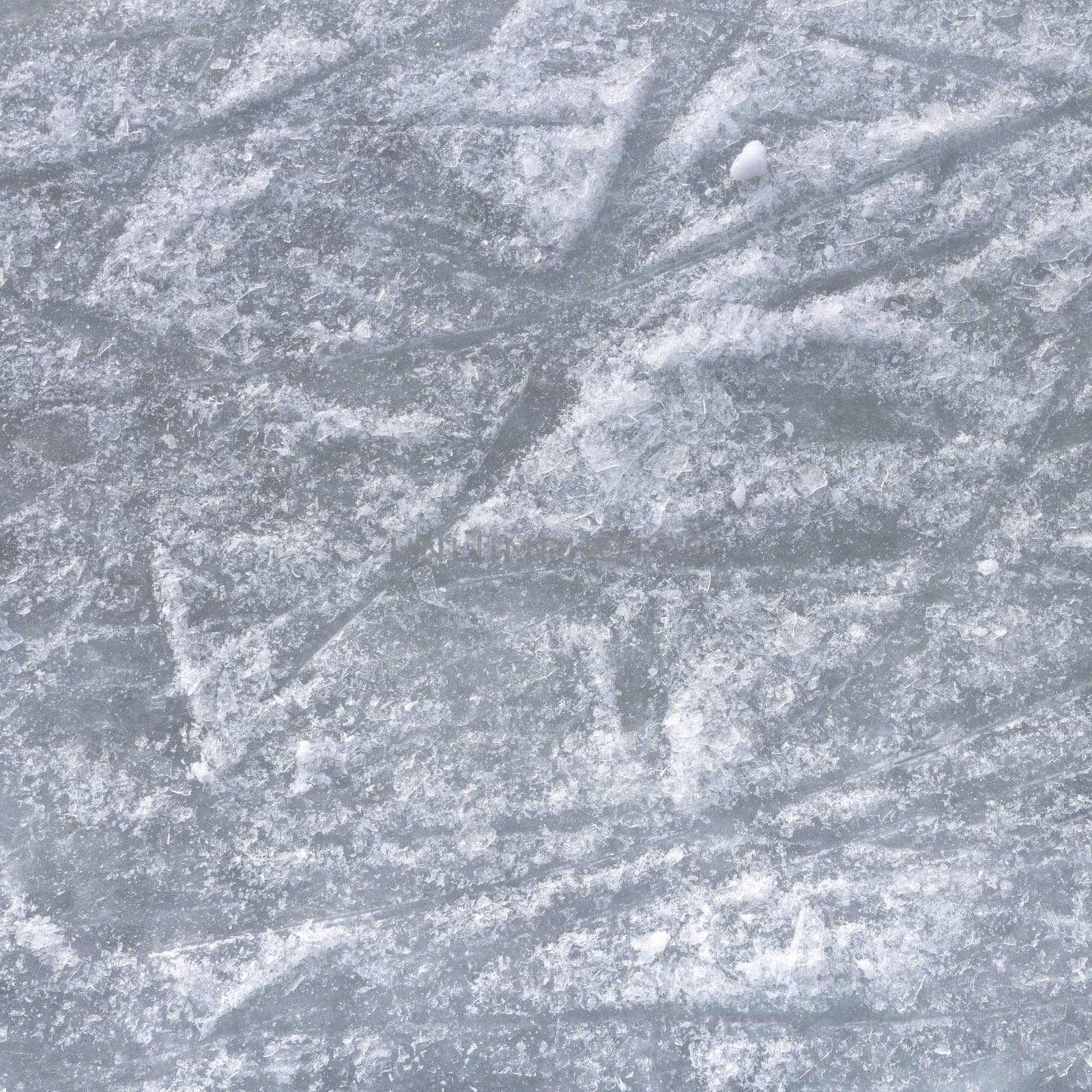 Ice surface. Close up of white ice surface with a traces left by the skates. Ideal for texture and backgrounds.