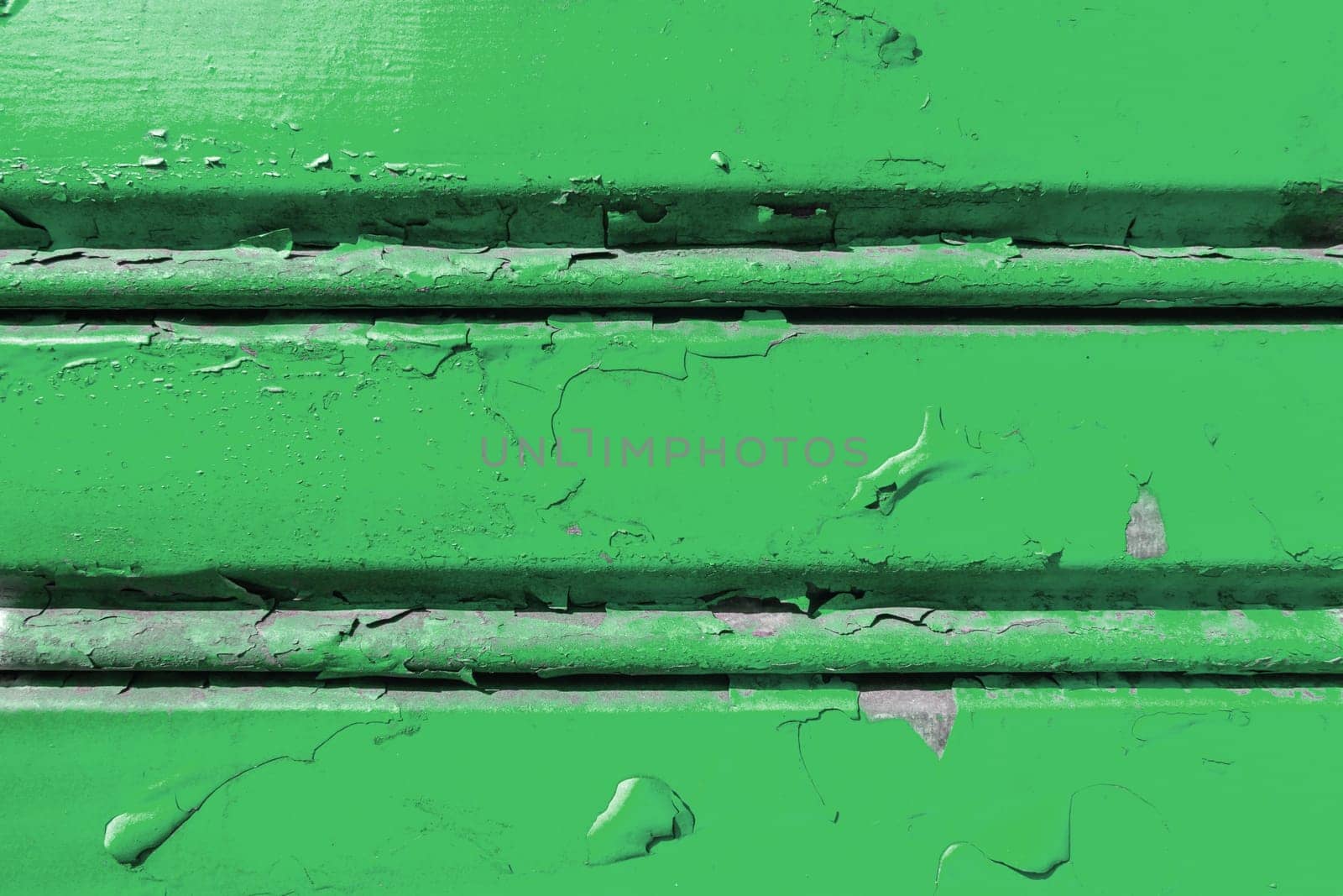 Background of old metal sheet with peel paint texture surface. Painted metal roller shutters door with peeling paint dirty green hue. Grungy background texture.