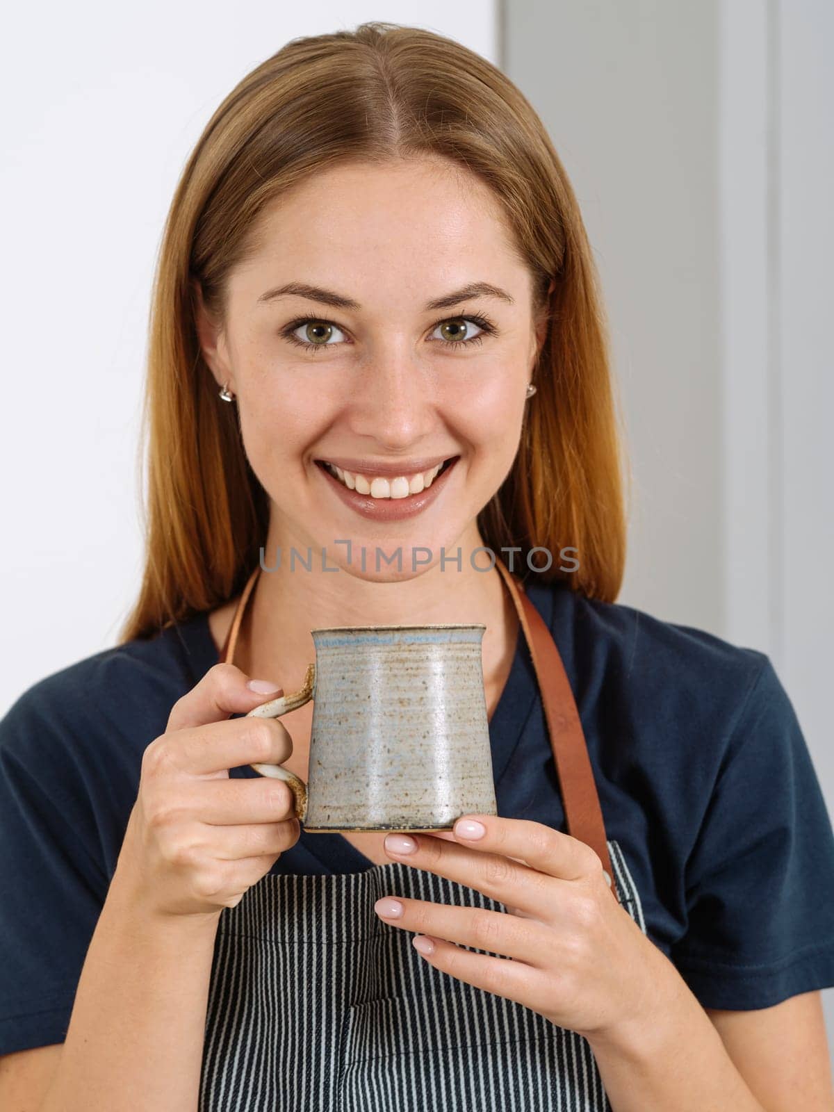 Happy and smiling gorgeous woman drinking coffee in an urban café.