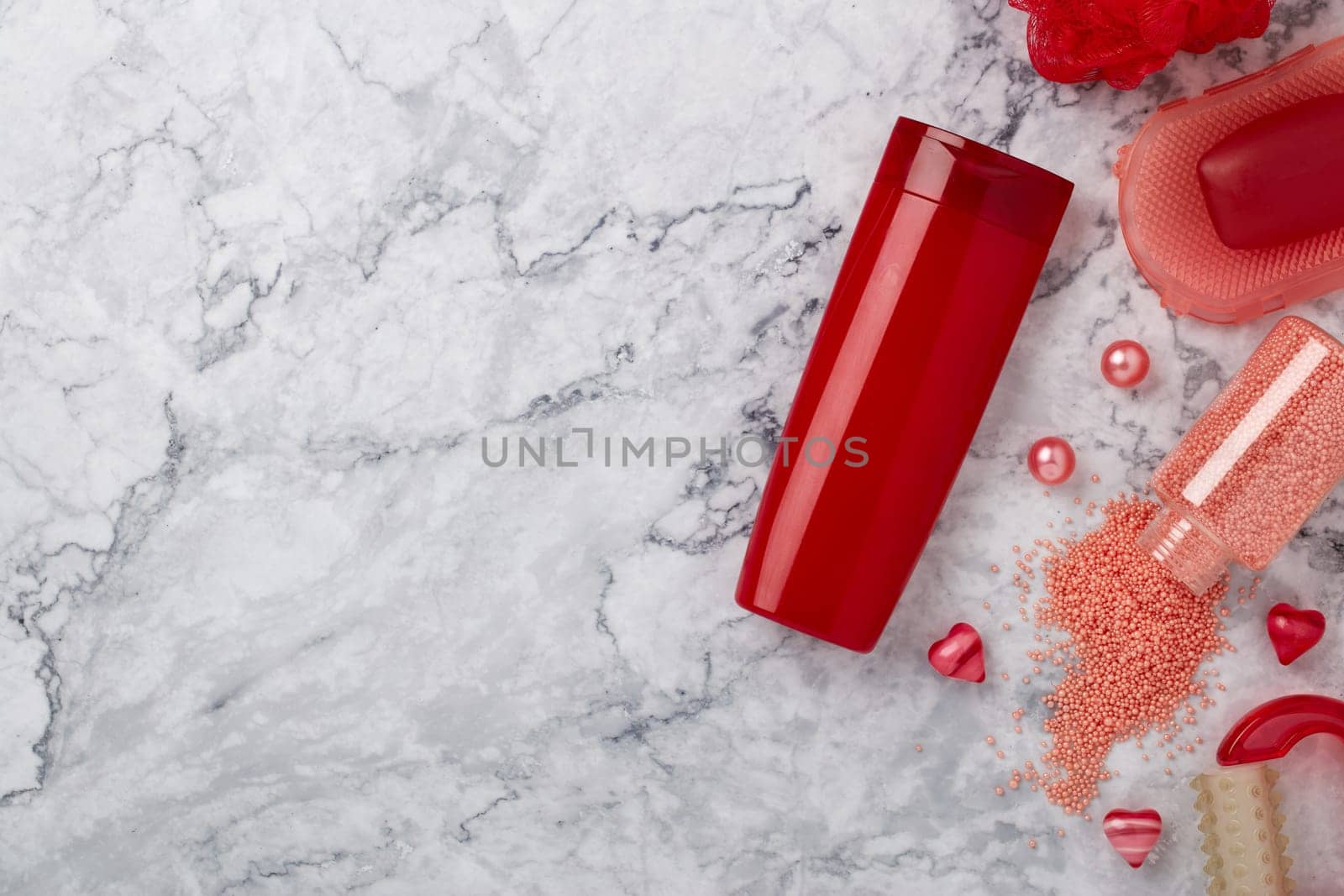Spa still life with toiletry and  hearts on light  gray marble background. Top view with copy space. Healthy lifestyle, body care, Spa treatment. Valentine