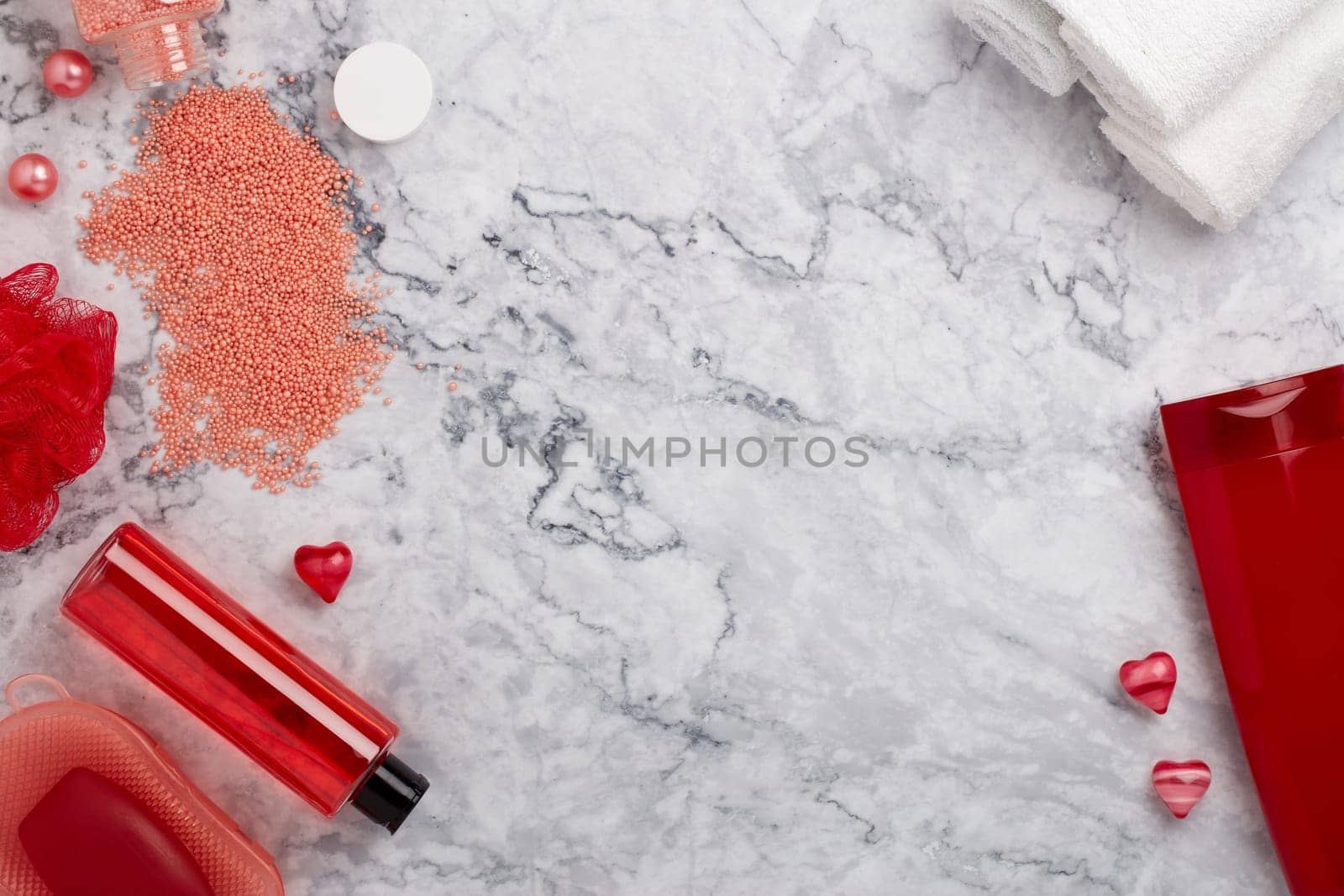 Spa still life with  toiletry, towel and  hearts on light  gray marble background. Top view with copy space. Healthy lifestyle, body care, Spa treatment. Valentine