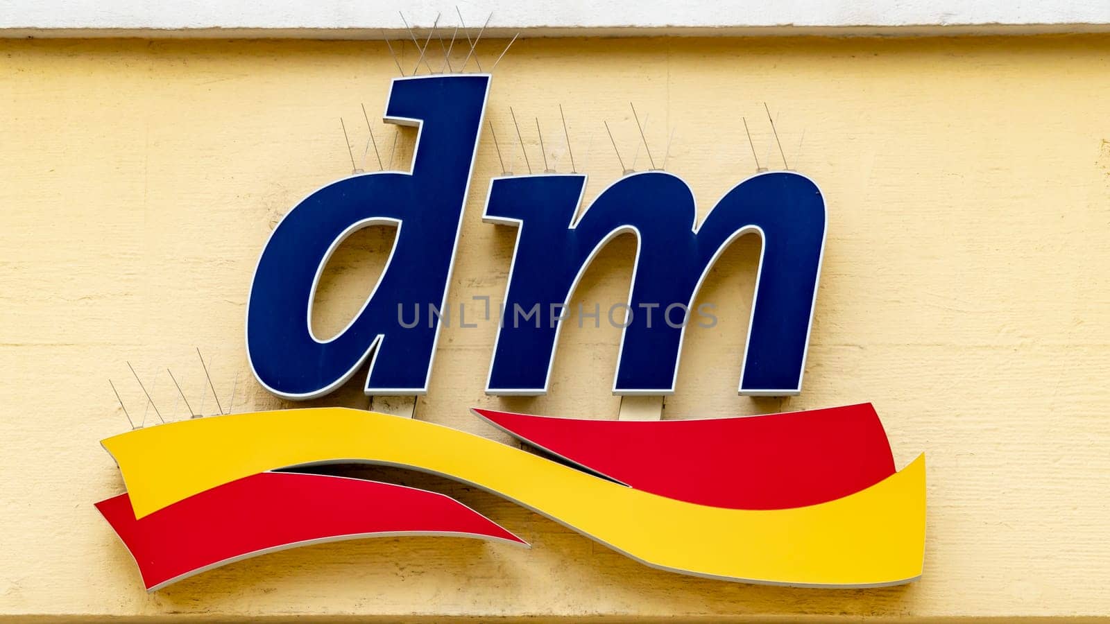 TRIER, GERMANY – SEPTEMBER 13 2019: Sign Logo of DM store. DM-Drogerie Markt is a chain of retail stores. Selling cosmetics, healthcare products and healthy food.