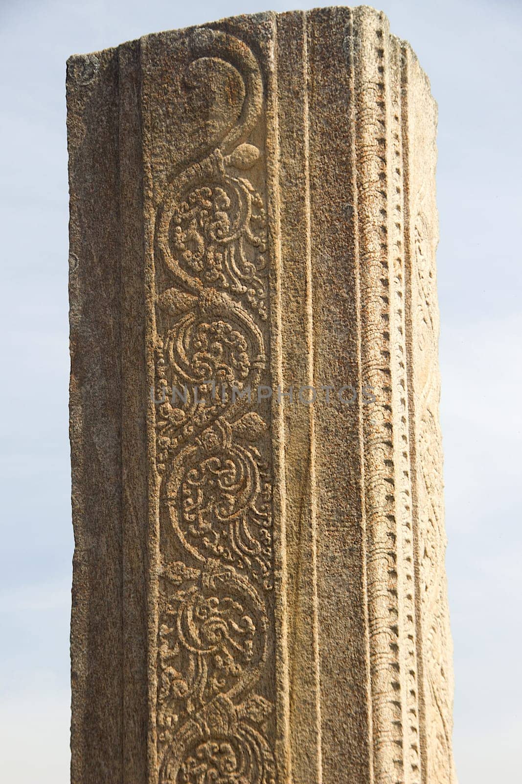 Closer view of beautiful floral design on stone pillar at Rayara Gopura in Melukote, Mandya district, Karnataka, India, Asia