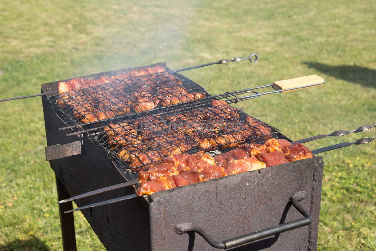 Custom made rusty metal barbeque with meat on it