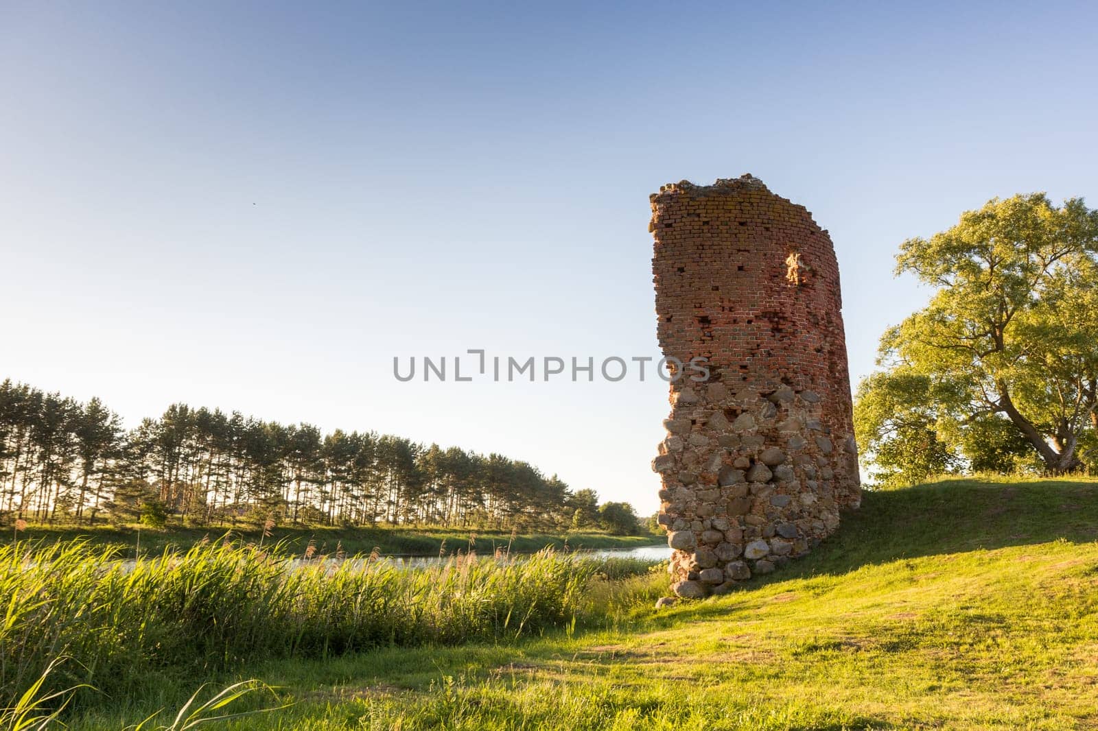 Old castle tower ruins in Latvia Piltene near river Venta