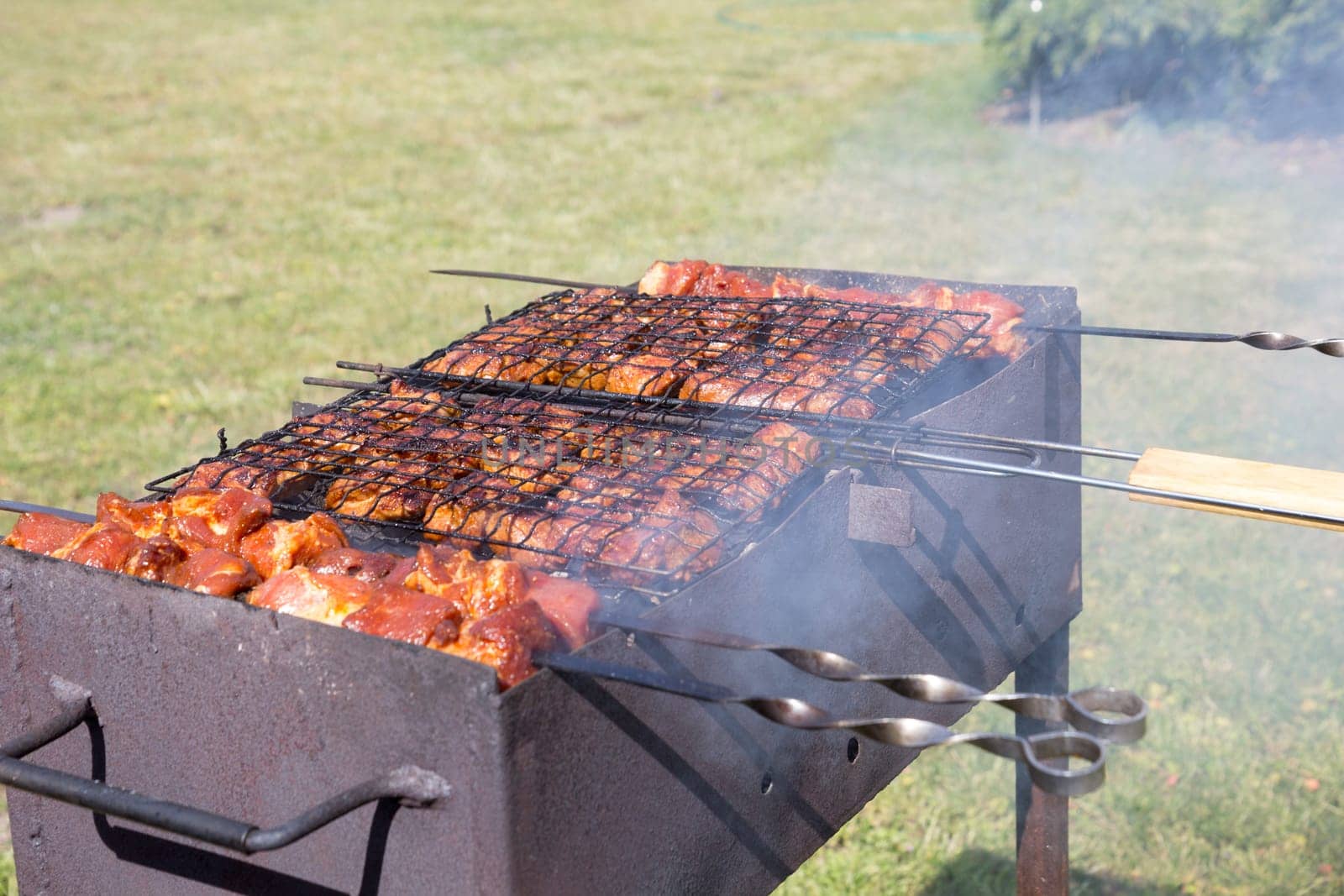 Custom made rusty metal barbeque with meat on it
