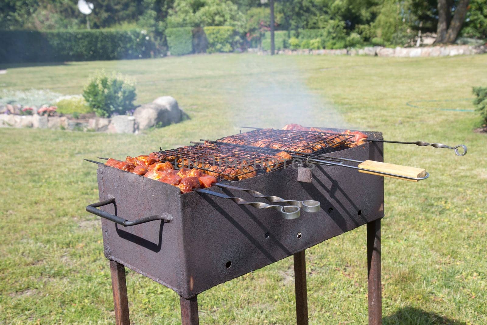 Custom made rusty metal barbeque with meat on it