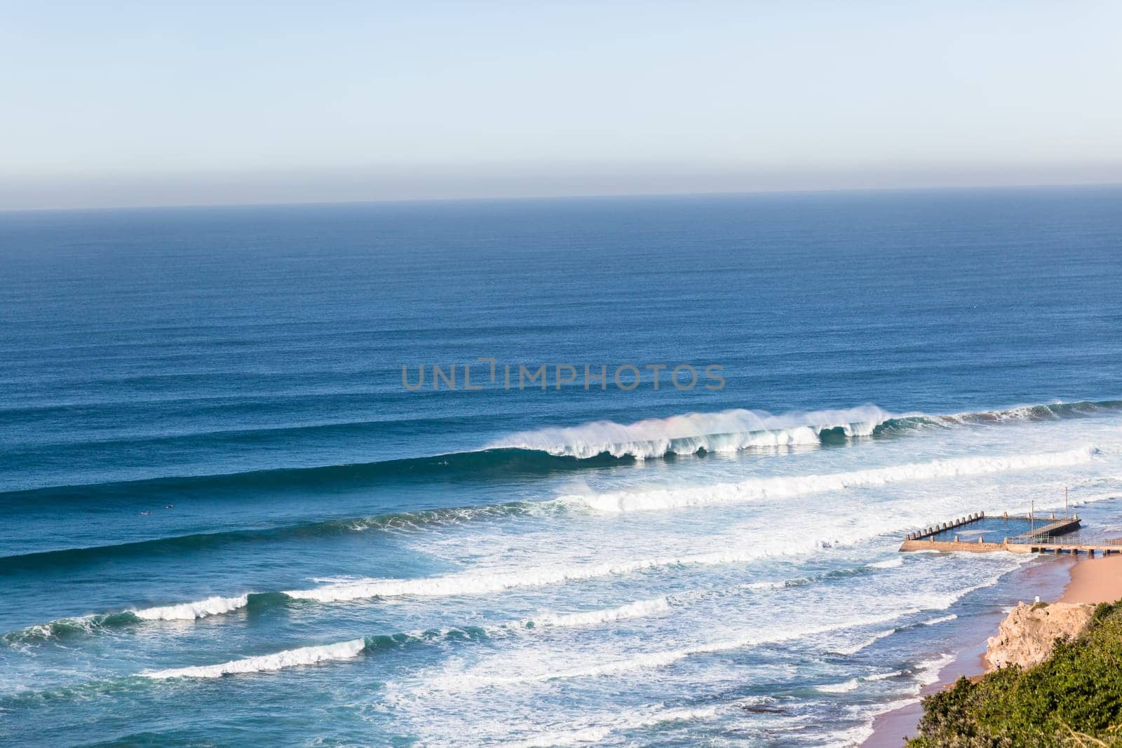 Wave swell crashing on coastline shoreline a birdseye air photo