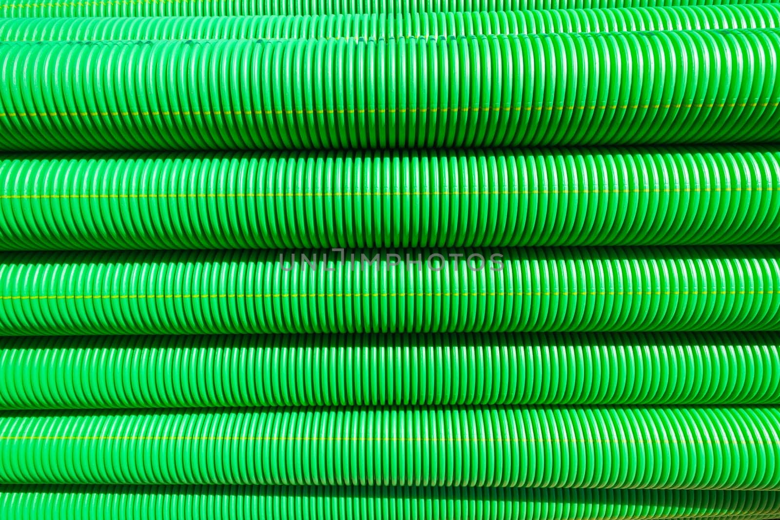 Plastic drainage pipes closeup green black abstract background detail