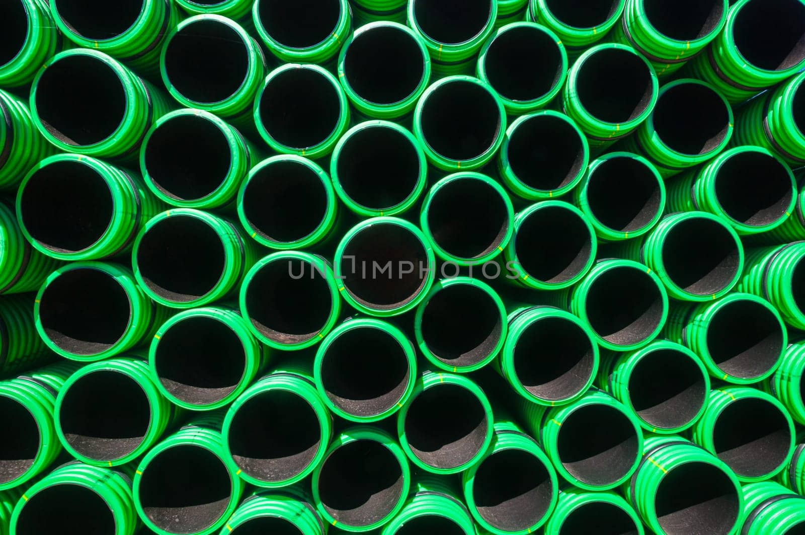 Plastic drainage pipes closeup green black abstract background detail