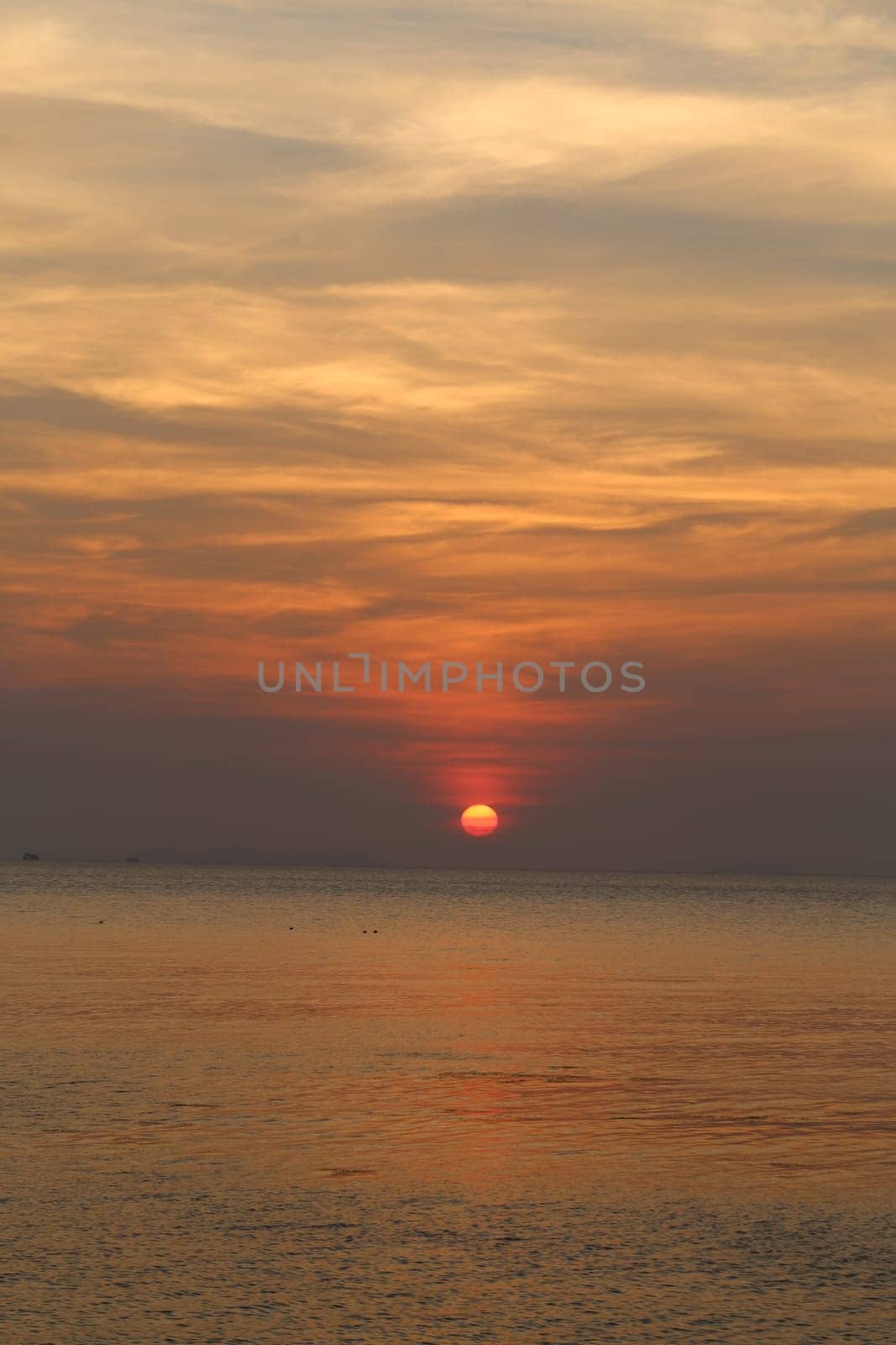 Sunset in the sea among the clouds