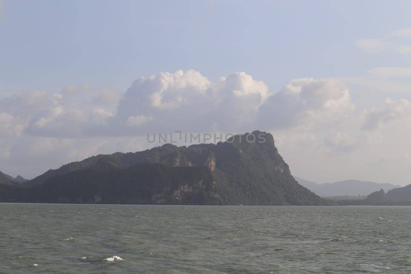beautiful seascape with the island on the background of blue sky with