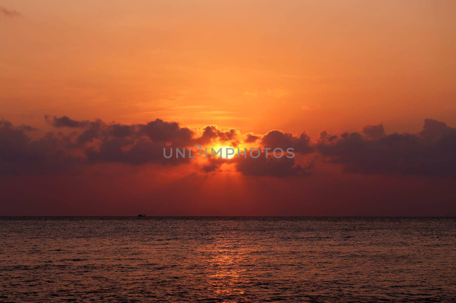 Sunset in the sea among the clouds
