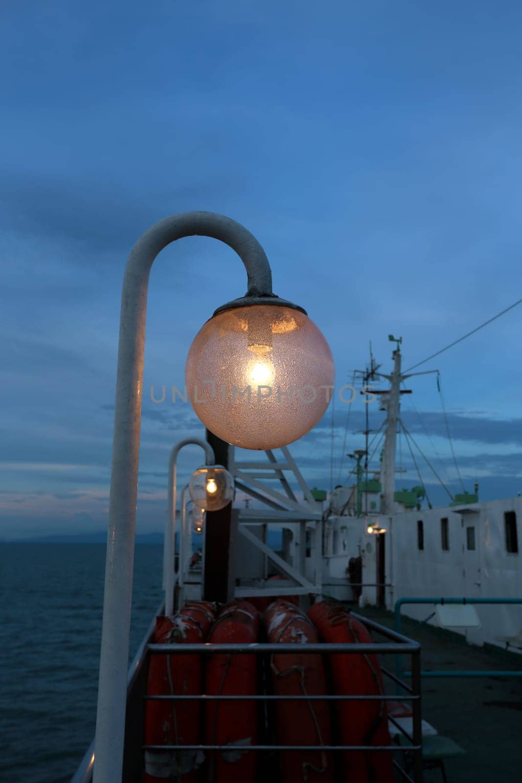 The lantern on the ferry on the background of blue sky and sunset