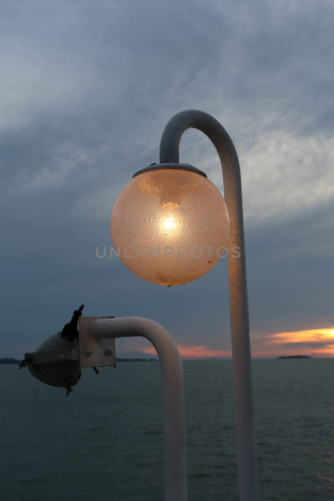 The lantern on the ferry on the background of blue sky and sunset
