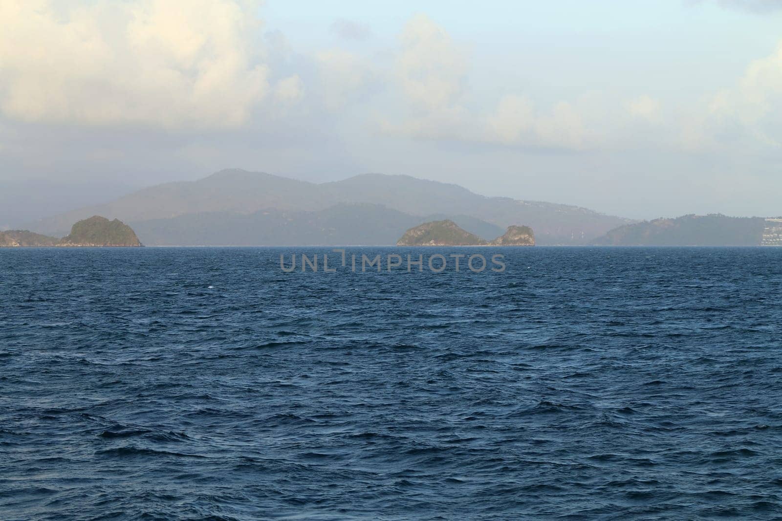 beautiful seascape with the island on the background of blue sky with