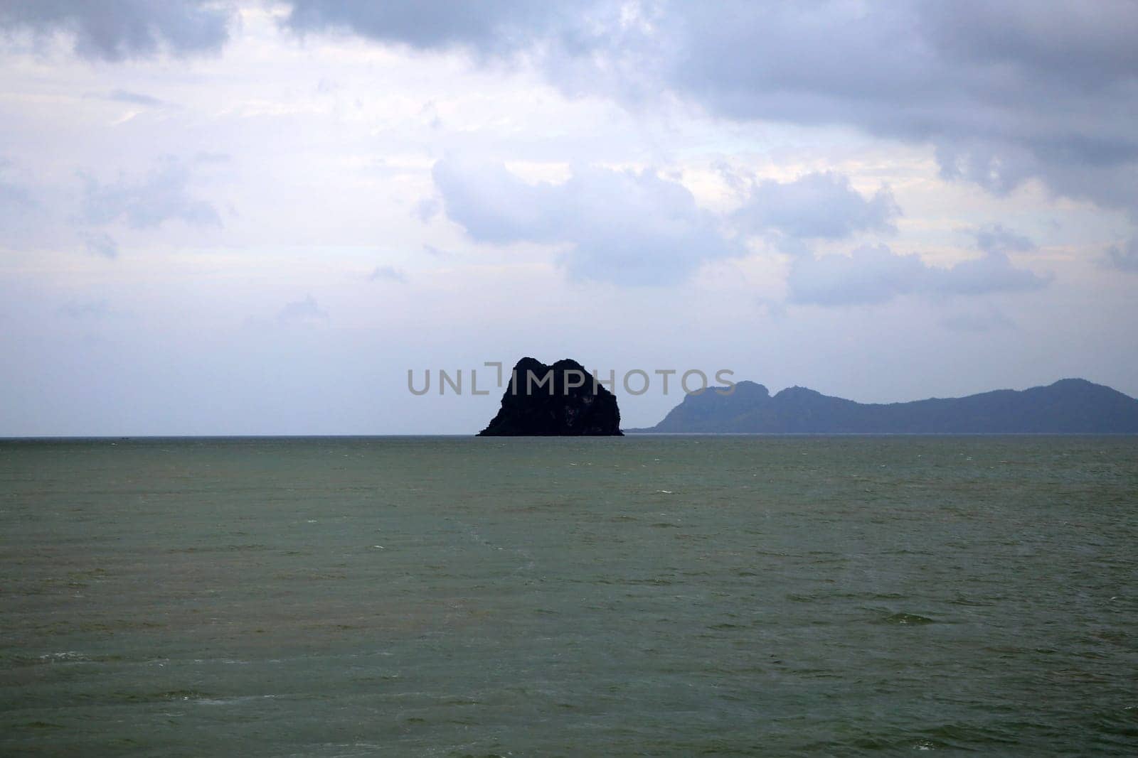 beautiful seascape with the island on the background of blue sky with