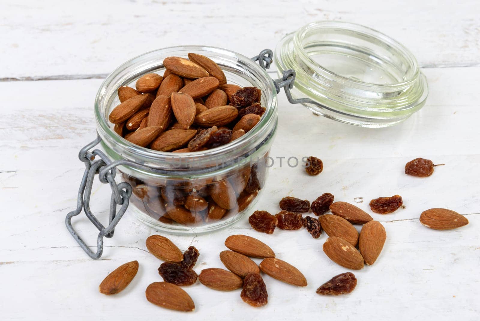 almonds with raisins dry in a glass jar