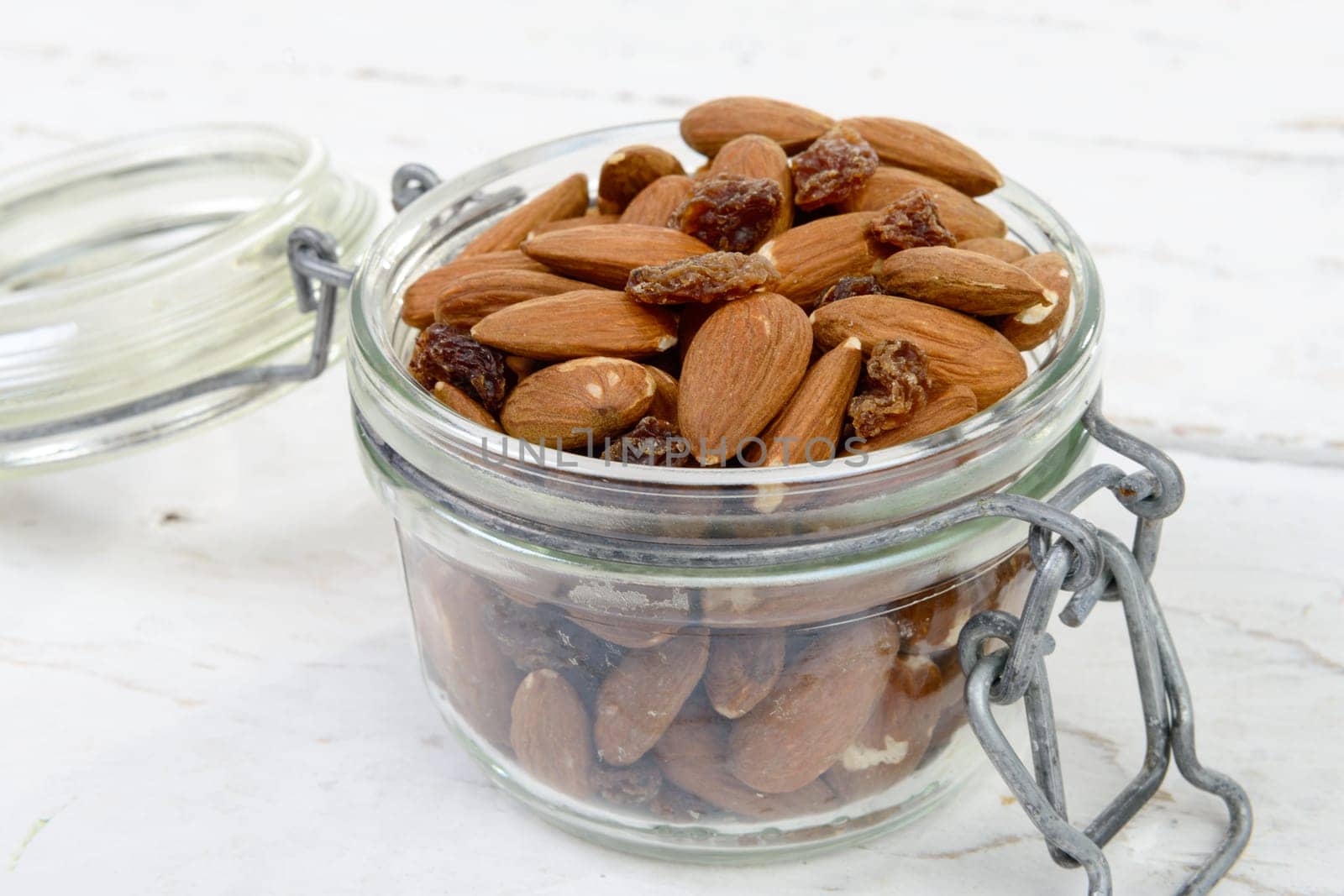 almonds with raisins dry in a glass jar