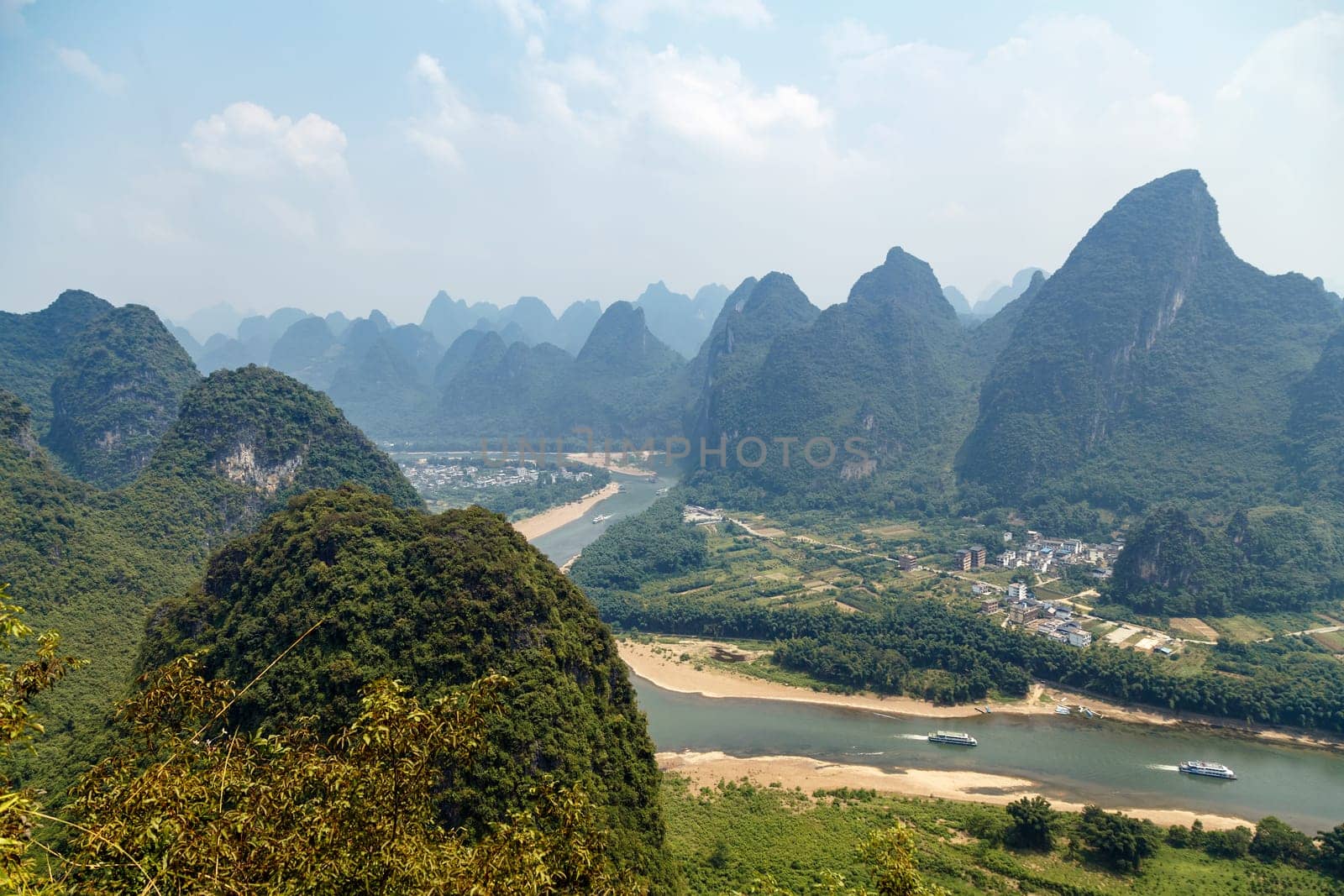 Picturesque mountains Yangshuo, Guilin, China with river and valley below