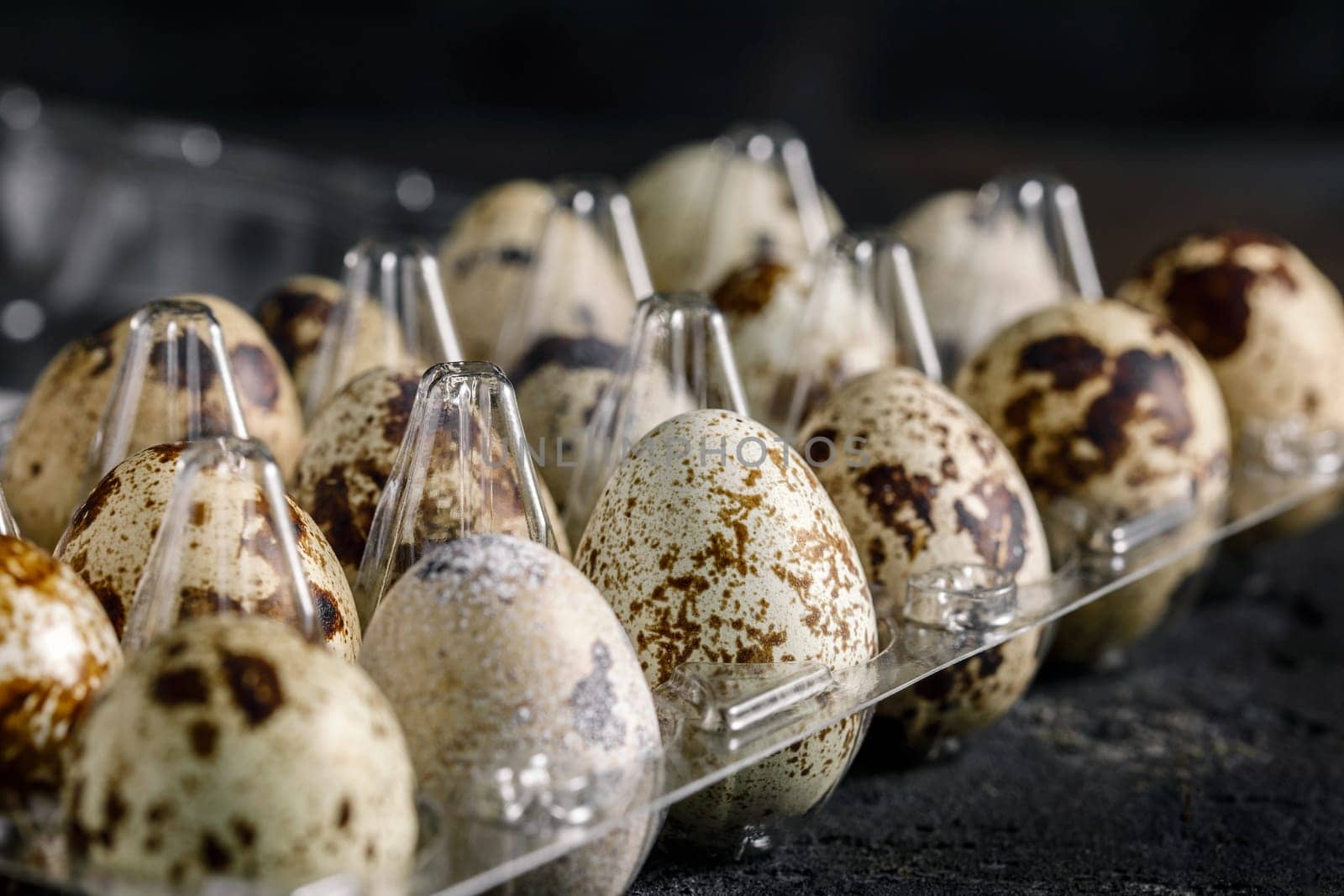 Fresh quail eggs in a transparent lattice, selective focus