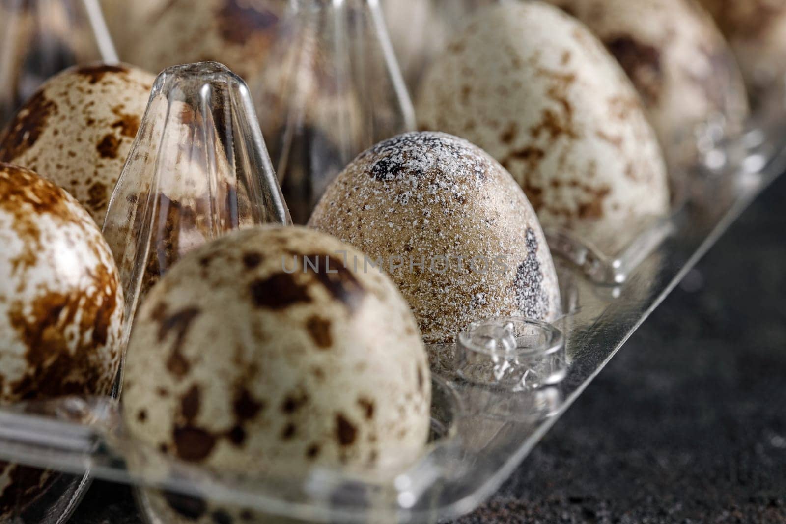Fresh quail eggs in a transparent lattice, selective focus