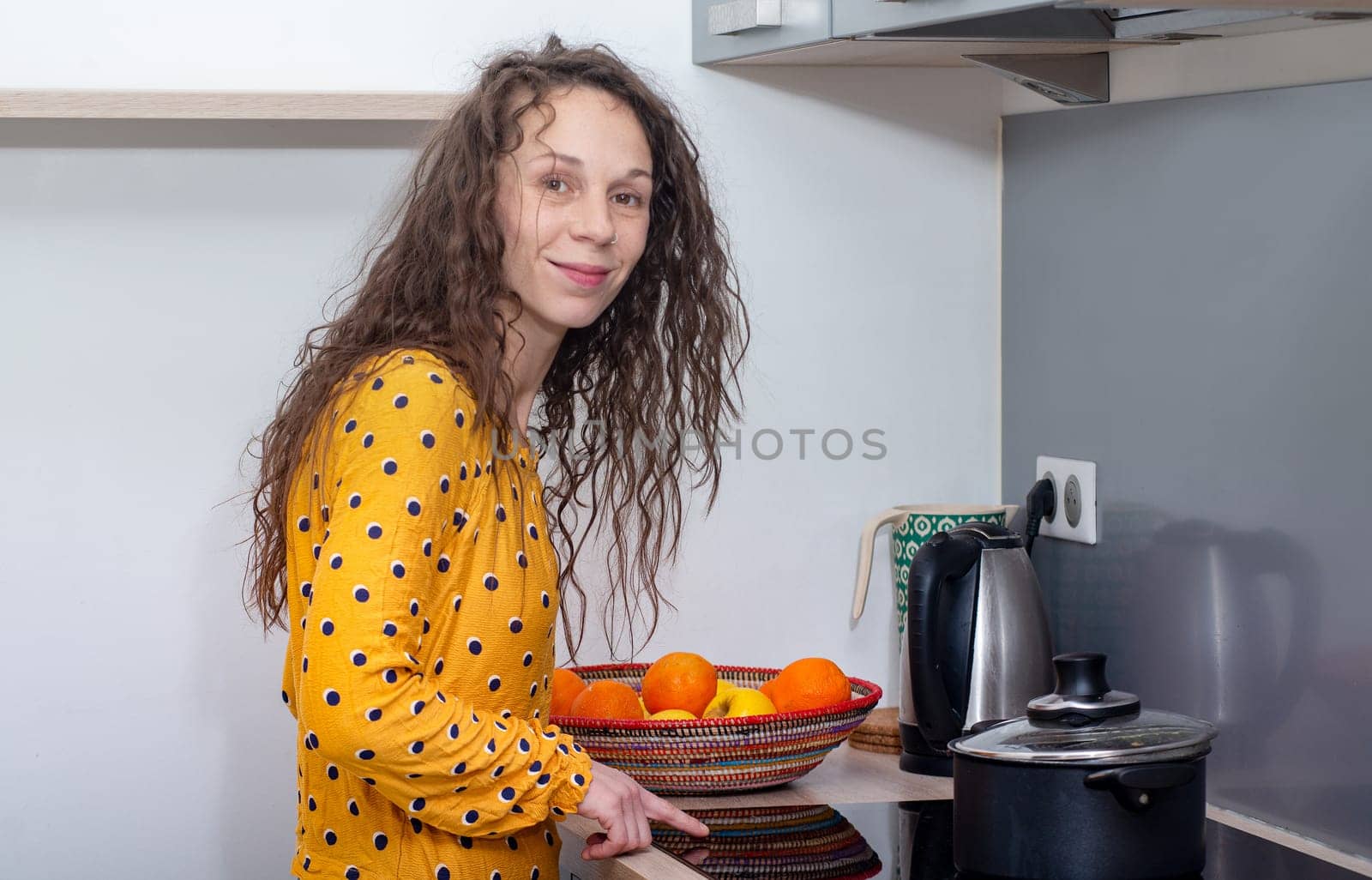a young woman with long hair is in the kitchen