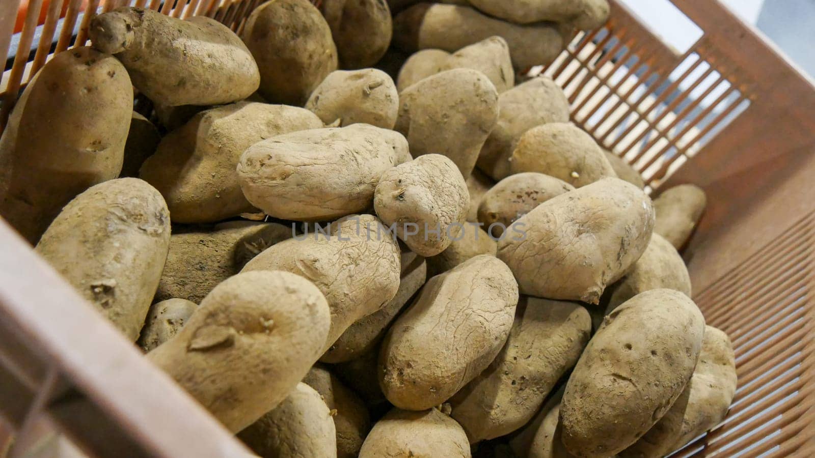 crate of organic potatoes on the market place