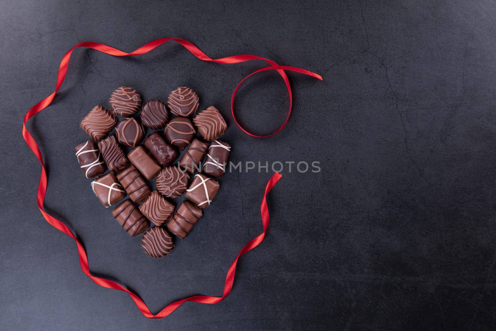 Chocolate pralines  for Valentines day or Mothers day concept on black background