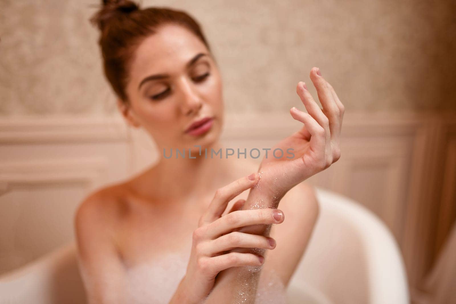 Young woman skincare in bathroom. Beautiful nude woman washing in bathtub.