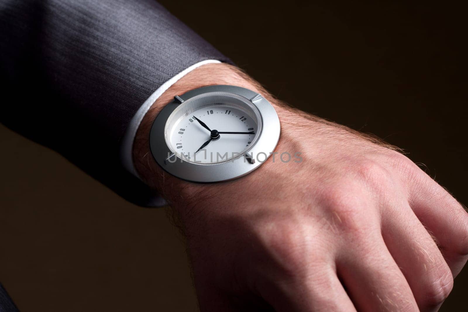 Business time - businessman looking to watch in hand