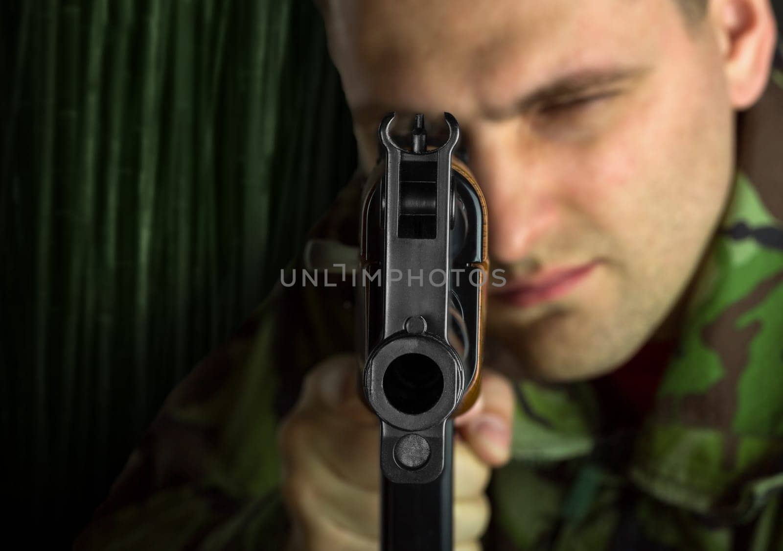 Soldier with rifle AK-47 aiming to you