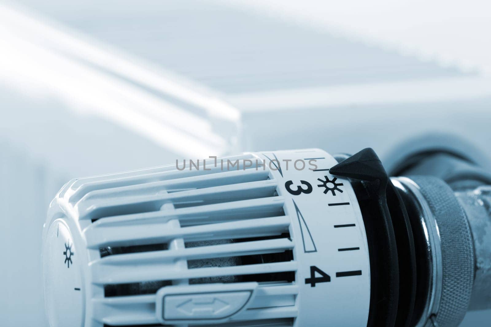 Closeup of heating radiator thermostat. Toned in blue