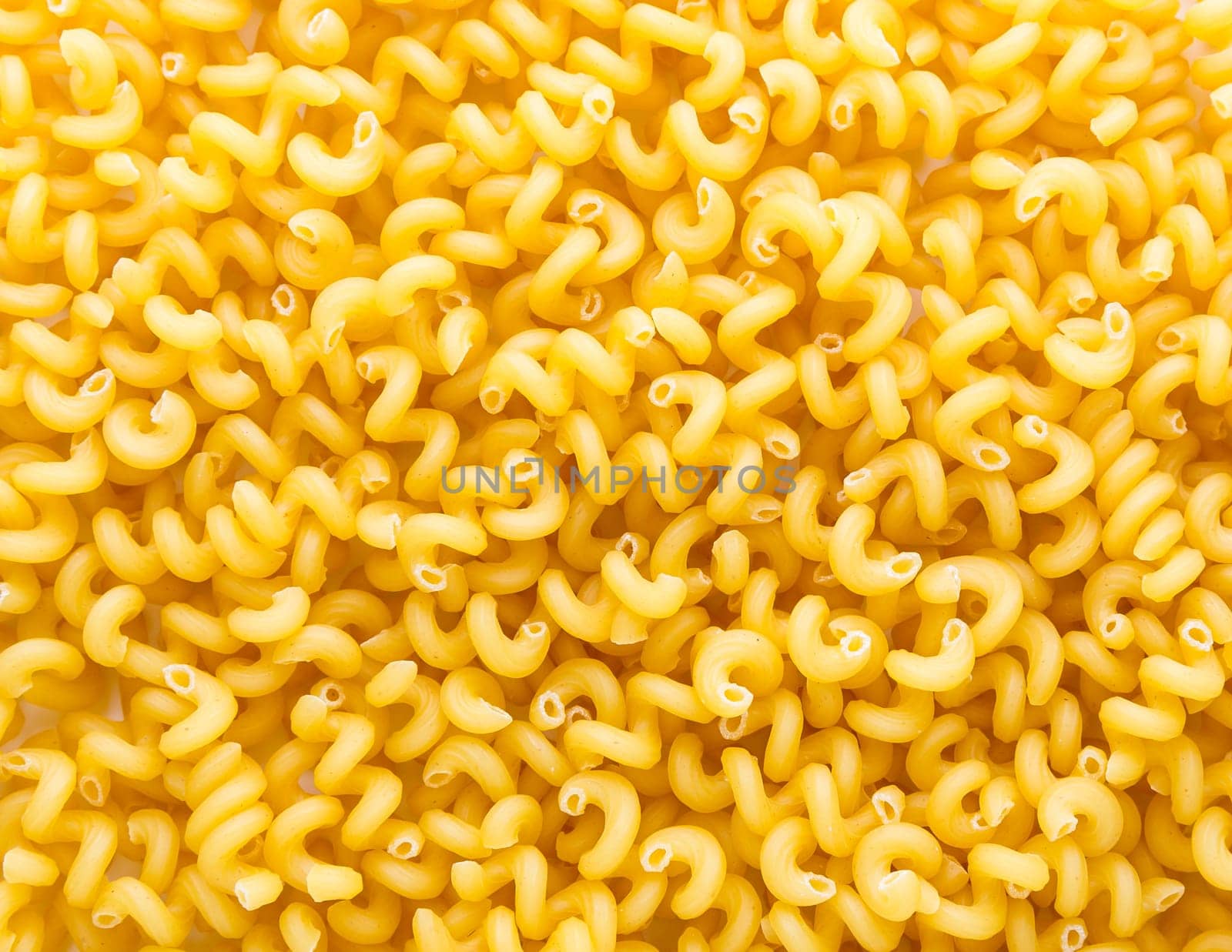 Heap of yellow macaroni. Background