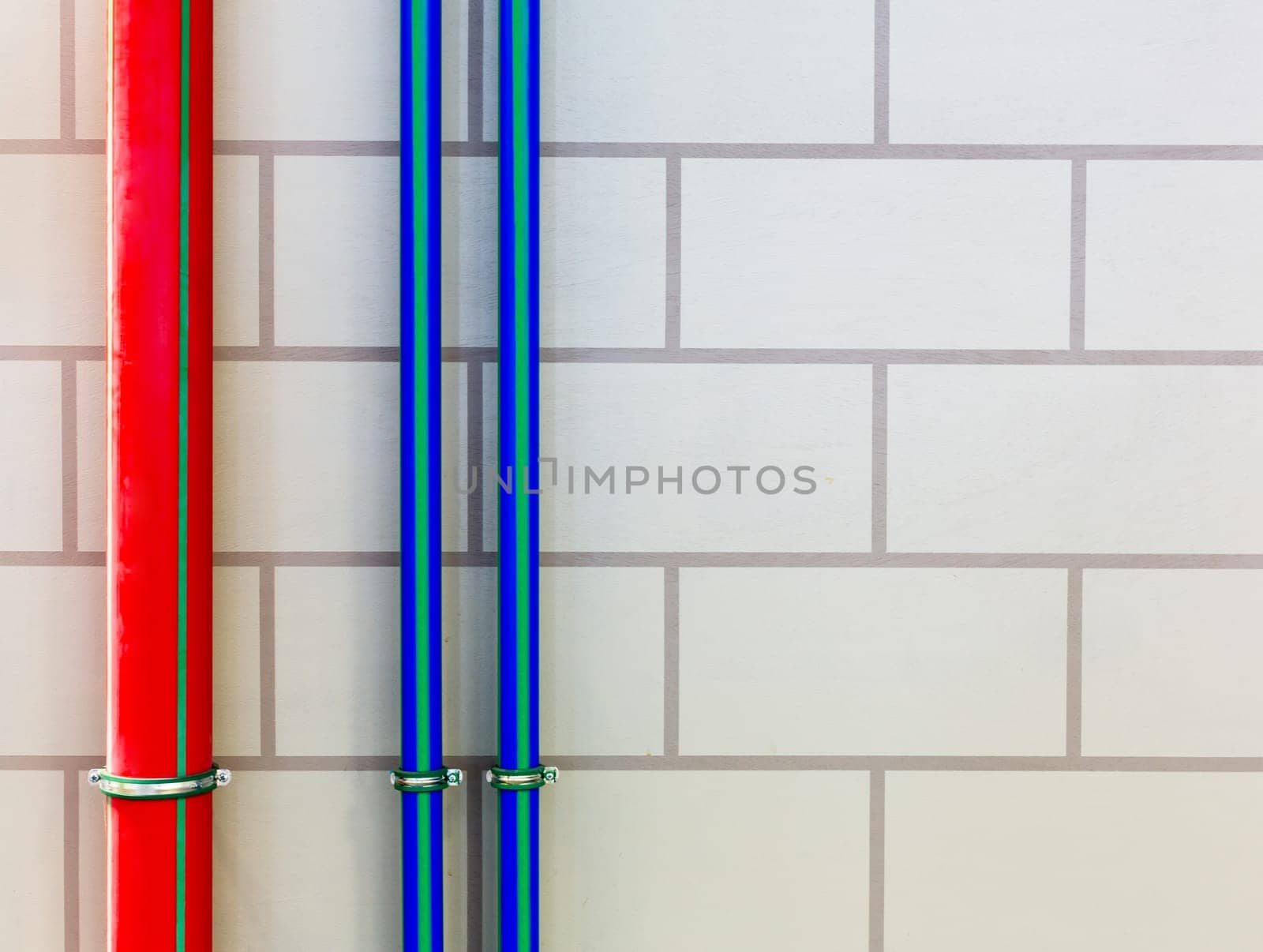 Red and blue water pipes on the wall
